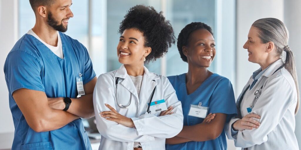 Healthcare, medicine and teamwork with a doctor, nurse and health workers working as a team in the hospital. Collaboration, medical and trust with a healthcare group at work in a clinic for care.