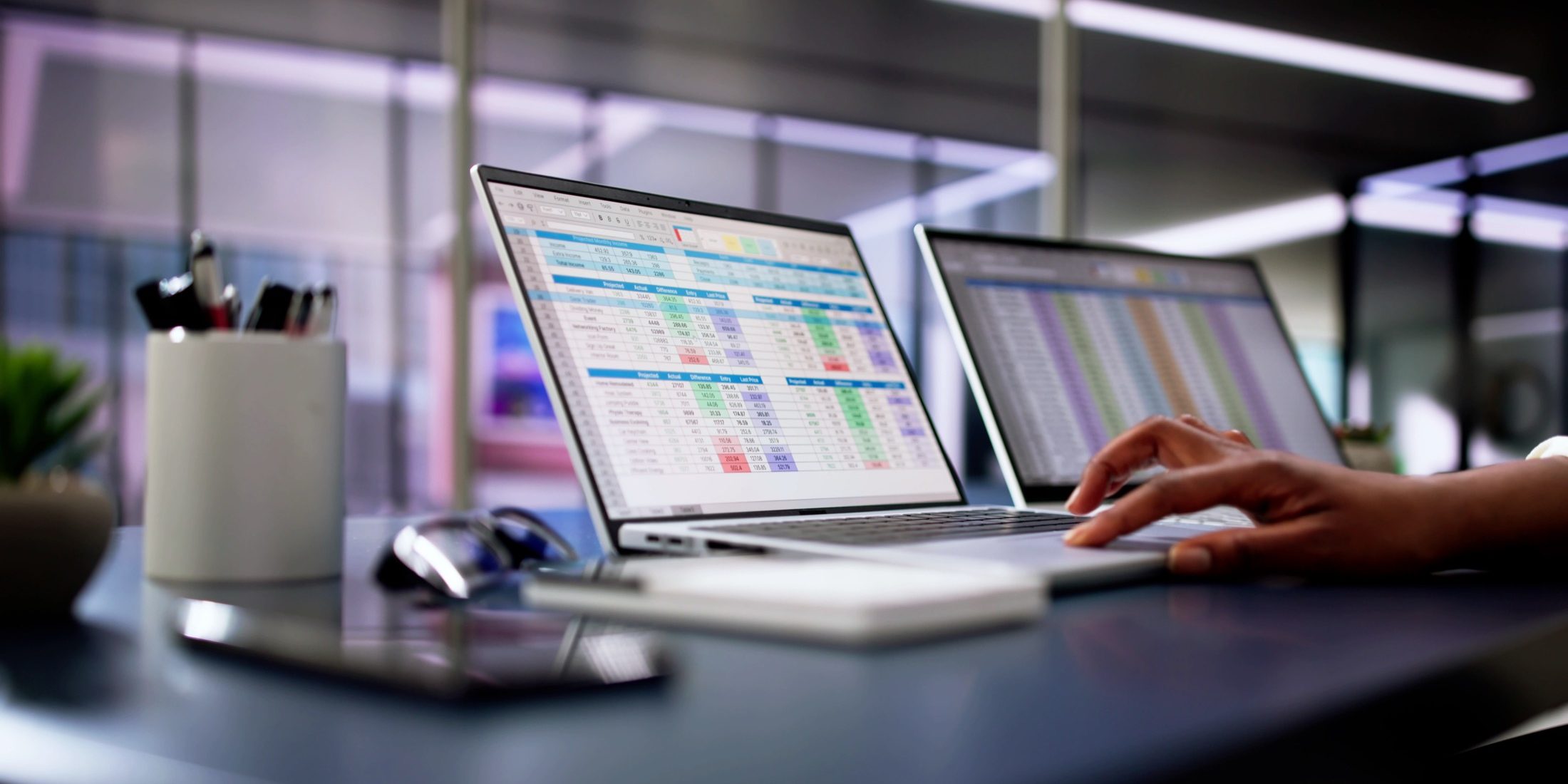 Calculating electronic medical accounts and codes in a black office using a spreadsheet on a computer screen.