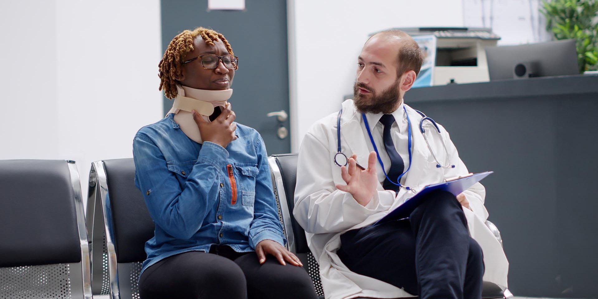 Female patient with cervical neck foam talking to doctor in waiting area at healthcare facility. Hurt woman in pain with collar brace trying to cure physical injury, help from medic. Handheld shot.
